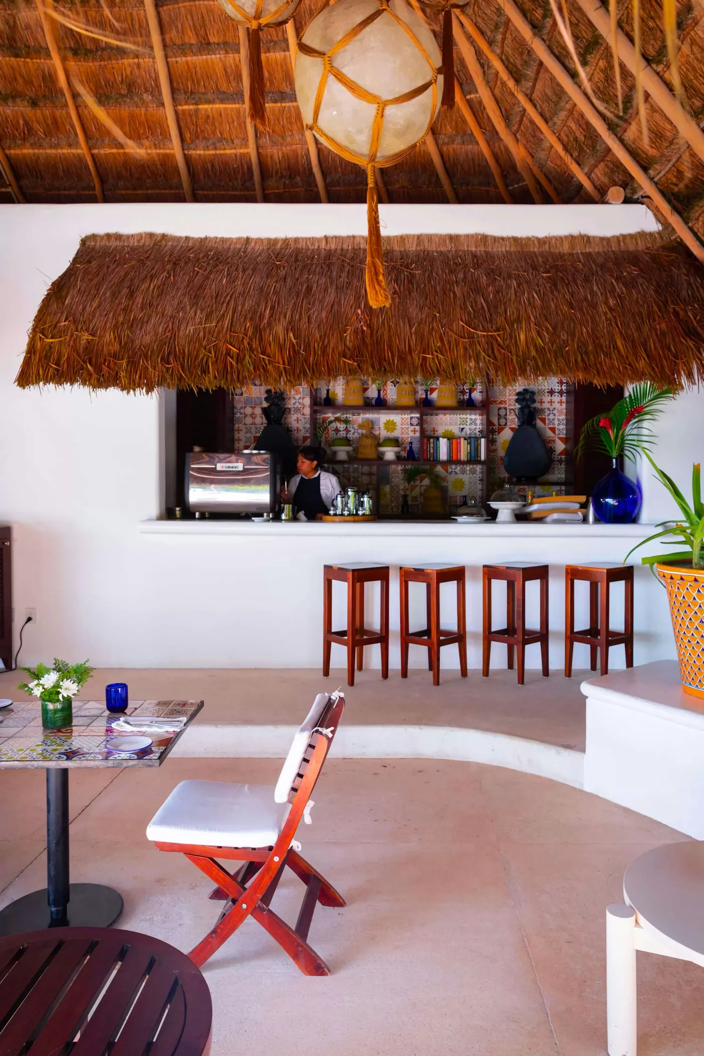 Open-air café bar beneath a thatched roof in the Riviera Maya