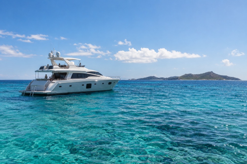 Private yacht anchored offshore in clear Caribbean water